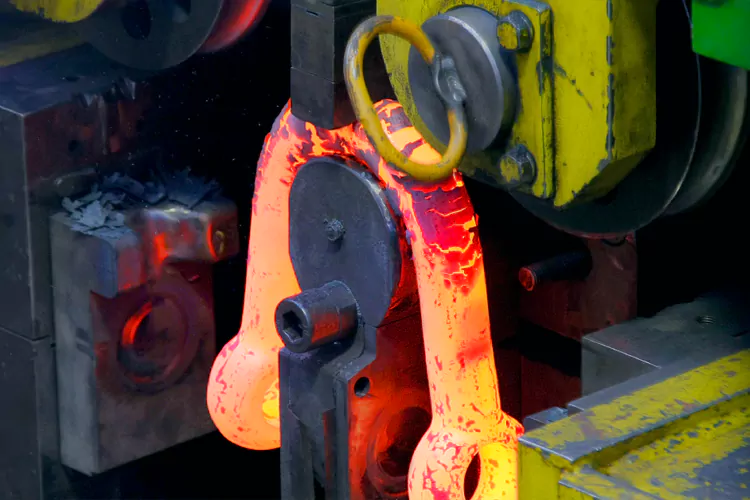 a hot forged shackle body during forming at powerful machinery